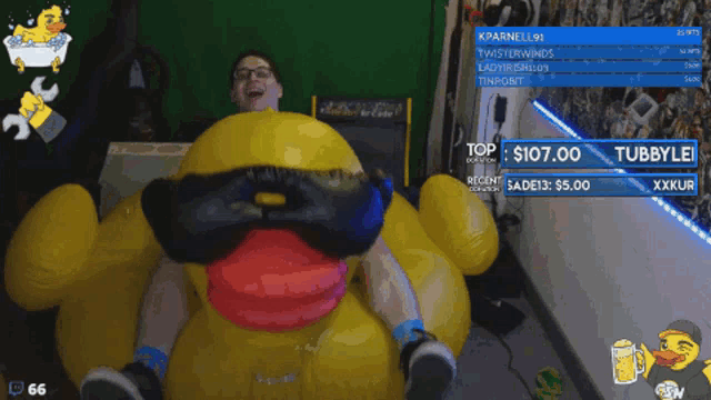 a man in a blue shirt is sitting on a yellow inflatable chair