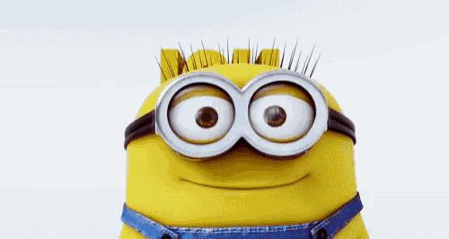 a close up of a minion wearing goggles and smiling