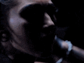 a close up of a woman 's face with black makeup .
