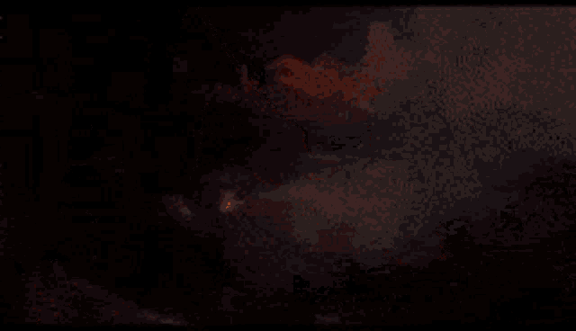 a close up of a pumpkin that is burning in the dark .