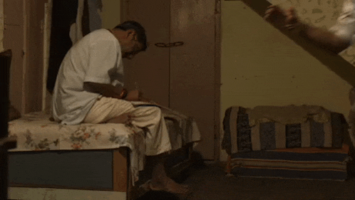 two men are standing next to each other in a room .