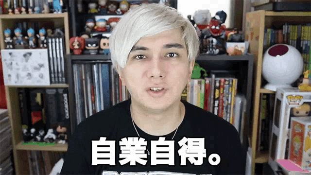 a man with white hair is wearing a black t-shirt with chinese writing on it