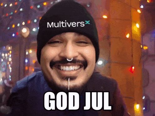 a man with a beard wearing a black multivers hat