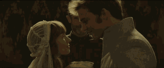 a man and a woman are kissing and the woman is wearing a white hat
