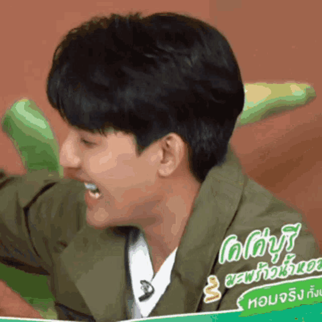 a man wearing a green jacket has a sticker on his jacket that says ' ao ' on it