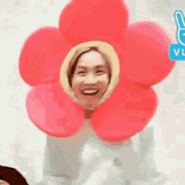 a woman is wearing a flower costume with a flower headband .