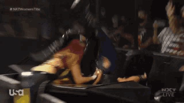a woman with red hair is laying on the ground while a man holds her legs .