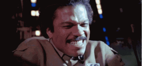 a man with a mustache is smiling and making a face .