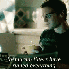 a man is sitting in front of a laptop with the caption instagram filters have ruined everything .