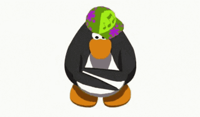 a penguin wearing a green and purple hat .