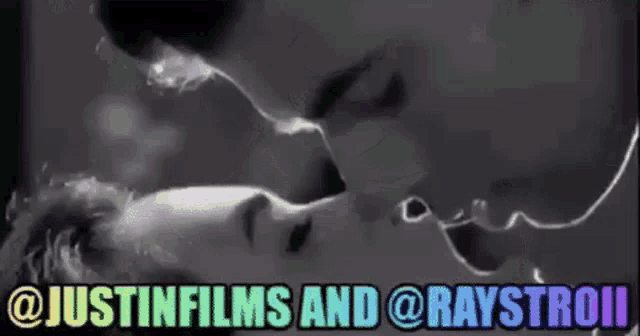 a man and a woman are kissing in a black and white photo with the words justinfilms and raystromi written below them .