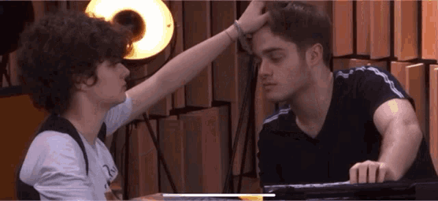 a man with curly hair is being touched by a woman