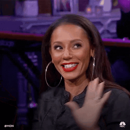 a woman with red lips and hoop earrings is smiling