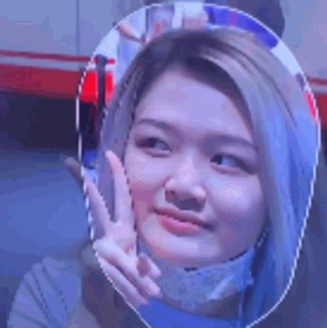 a woman with a mask on her face is giving a peace sign in front of a mirror .