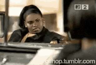 a gif of a woman looking at herself in a mirror with the website gifhop.tumblr.com in the corner