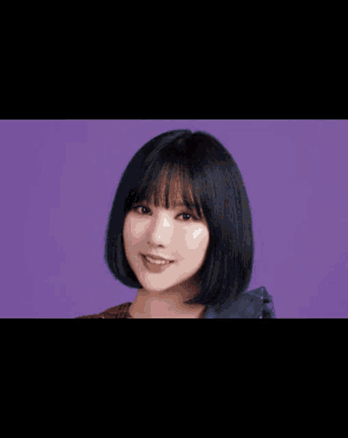 a close up of a woman 's face against a pink background