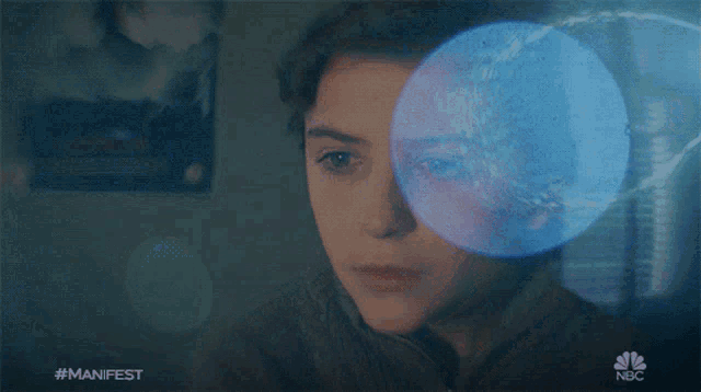a nbc ad shows a girl with a blue circle in front of her face
