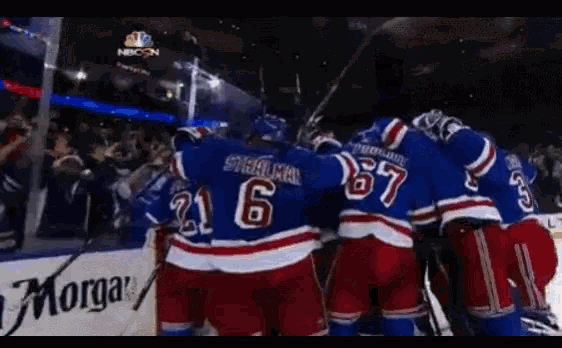 a group of hockey players are huddled together and one of them has the number 6 on his back