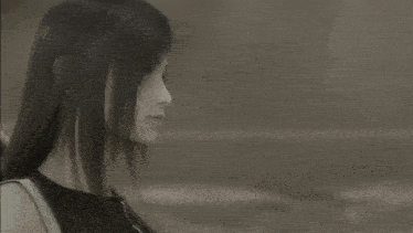 a black and white photo of a woman with long dark hair