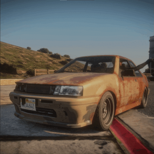 a rusted car with a license plate that says california