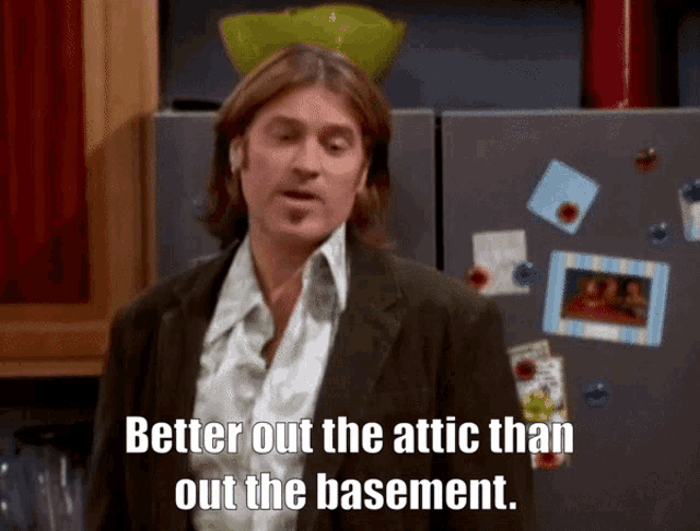 a man says better out the attic than out the basement in front of a refrigerator