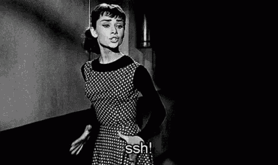 a black and white photo of audrey hepburn in a polka dot dress .