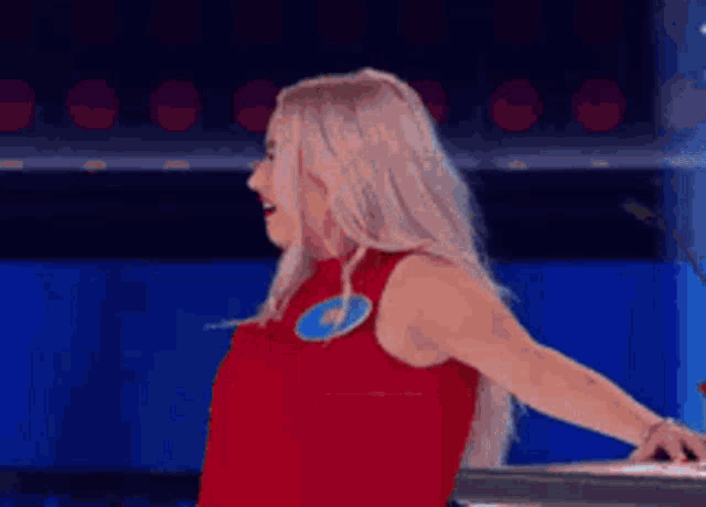 a woman in a red tank top with a blue lightning bolt on it