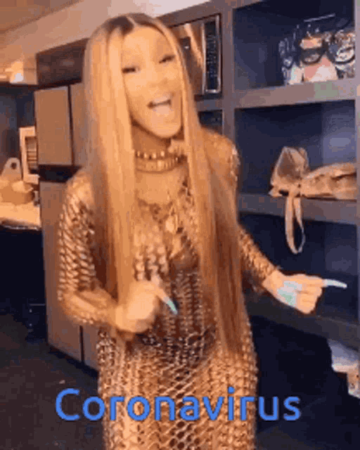 a woman in a gold dress is dancing in a kitchen with the words coronavirus written on the bottom of the picture .