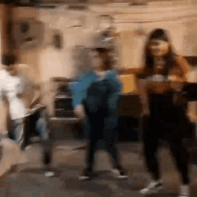 a blurry photo of a group of people dancing in a room