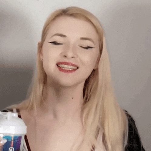 a woman with blonde hair is smiling while holding a shaker that says ' ice ' on it