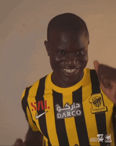 a man wearing a black and yellow striped shirt that says barco