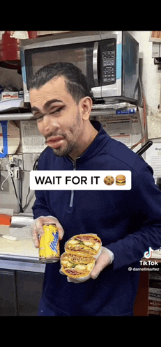 a man is holding a can of diet root beer and a sandwich