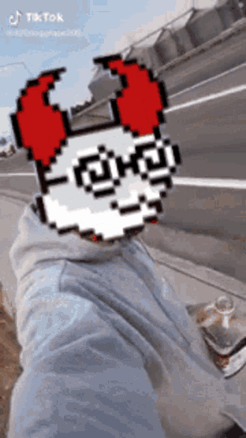 a person with a pixel art face on their face