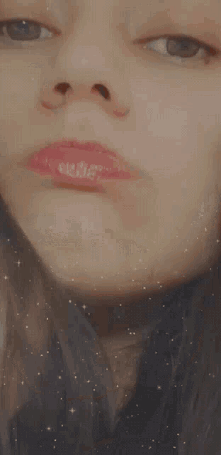 a close up of a woman 's face with her eyes closed and red lips