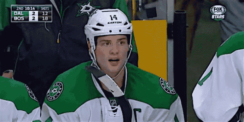 a hockey player wearing a helmet that says 14
