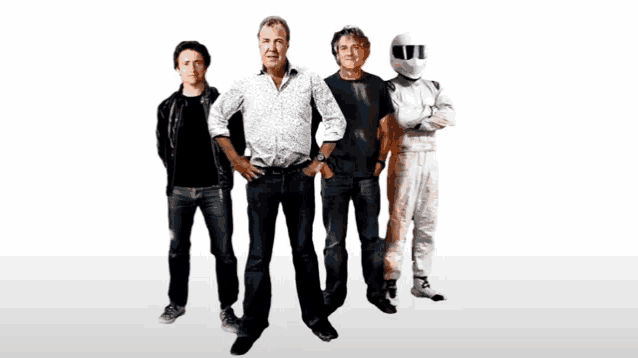four men standing next to each other with one wearing a white helmet