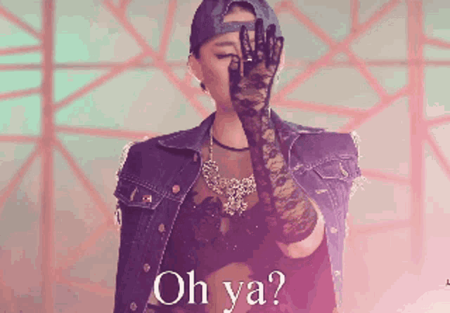 a woman in a denim jacket and black lace gloves covering her face with her hand and the words oh ya