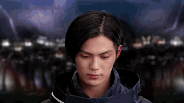 a man in a black jacket looks down at something