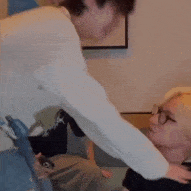 a man is putting his hand on another man 's neck .