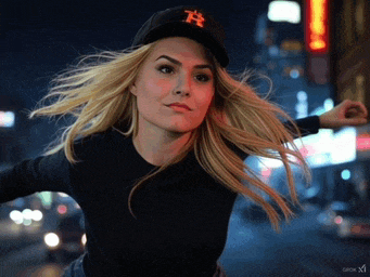 a woman wearing a black hat with the letter r on it
