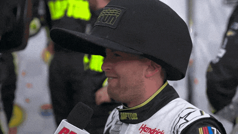 a man wearing a hendrick 's jacket and hat