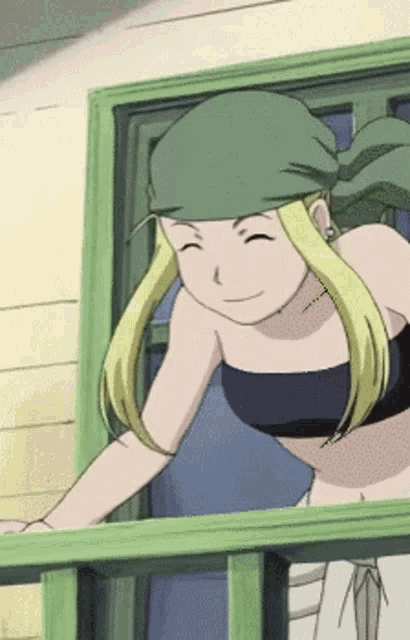 a woman with blonde hair and a green headband is smiling