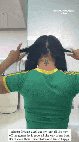 a woman in a green shirt has a tattoo on her neck