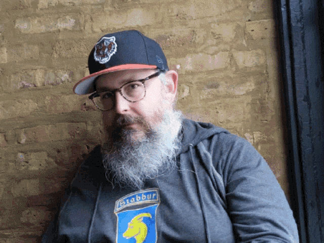 a man with a beard wears a bigbbur sweatshirt