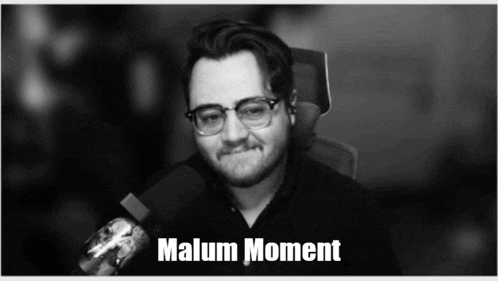 a black and white photo of a man with glasses and the words " malum moment "