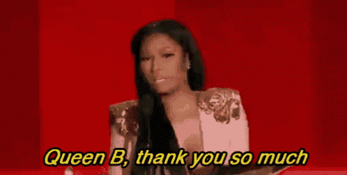 a woman is standing in front of a red background and says `` queen b , thank you so much '' .