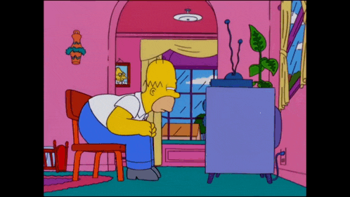 homer simpson sits in a chair in front of a tv