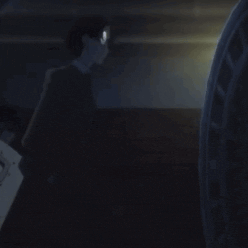 a man in a black suit is holding a shield