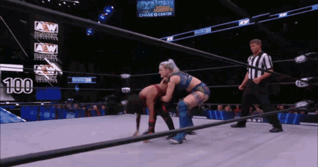 two women are wrestling in a ring with a sign that says aew on it