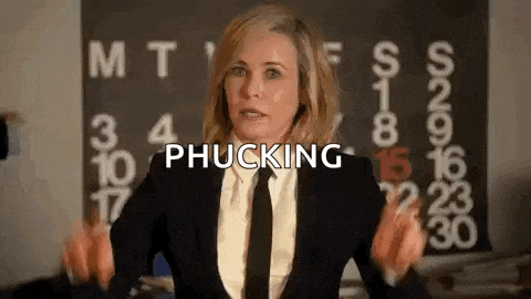 a woman in a suit and tie is standing in front of a calendar with the words phucking written on it .